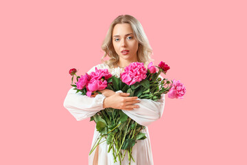 Poster - Young woman with beautiful peony flowers on pink background