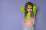 Stylish modern girl with a braided hairstyle with lots of braids of colored strands of artificial hair