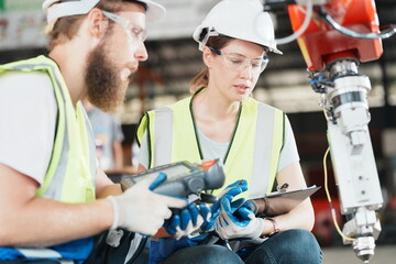 Wall Mural - Industrial Engineer at work in factory, industrial engineers working at automated AI robotic production factory - New technology concept