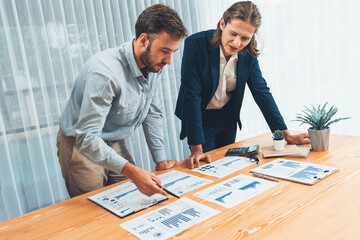 Analyst team in office analyzing financial data analysis for marketing strategy in workspace, pile of BI dashboard paper format with graph and chart to optimize performance and risk management. Entity