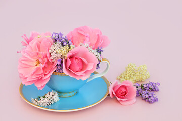 Wall Mural - Surreal adaptogen rose, valerian, lavender and elder flower design in tea cup on pink. Fun food herbal medicine composition. Flowers have relaxation health benefits.