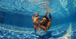 Funny photo of happy active family young father with active baby diving in swimming pool with fun jump deep down underwater.