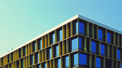 berlin office building with a retro vibe and big blue windows. modern minimalist building against bl