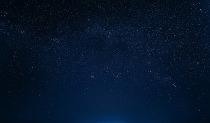 Wall Mural - Colourful Night Starry Sky In Blue Colors. Night Dark Blue Sky Glowing Stars Background Backdrop With Sky Gradient. Amazing View Sky. Traces Of Stars.