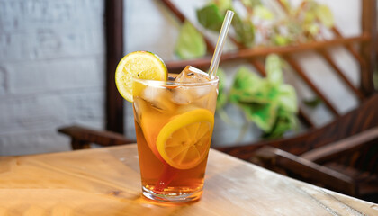 Wall Mural - Refreshing with glass of Iced Tea add Lemon juice on wooden table mai tai