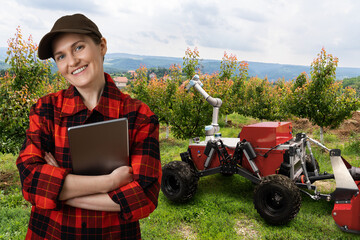 Sticker - Farmer controls autonomous robot in a fruit garden. Smart farming concept.