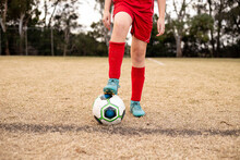 Close-up Of A Girl's Foot On A Soccer Ball At A Sports Oval