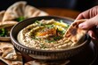 Hummus Served in a Bowl with Freshly Baked Pita Bread - Delicious Middle Eastern Cuisine Perfect for Snacking and Sharing - High-Resolution Food Photography