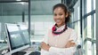 © M Stocker - Close up smiling face of young american african women flight attendant on the ground office a service standing with arms crossed looking at camera