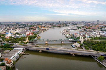 Wall Mural - Aerial shots taken from a drone of Phra Pok Klao Bridge and Phra Phuttha Yot Fa Bridge. crossing the Chao Phraya River in the morning with temple and palace in background at Bangkok, Thailand.