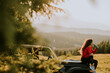 © BGStock72 - Young woman relaxing on a terrain vehicle hood at countryside