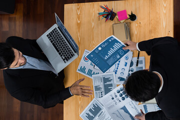 Poster - Top view analyst team discussing financial data on digital dashboard, analyzing chart and graph papers by data science software on wooden table background. Business intelligence and Fintech. Fervent