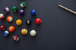 © DAVID - A top down view of a pool balls and a cue stick on a blue felt table.