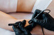 © Anastasiia Bielokon - Close up view of doctor is doing electroepilation to the client, using electro needle and tweezers. Hair removal procedure, professional beauty care. Beautcian's hands in gloves. High quality photo