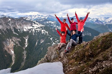 Group of happy friends on mountain top. Cheerful, active, healthy.  Canada. 