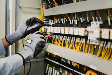 Electrical Engineers Test Electrical Installations And Wiring On Protective Relays, Measuring Them With A Multimeter.