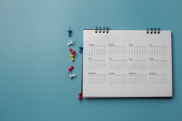 Wall Mural - Embroidered red pins on a calendar event Planner calendar,clock to set timetable organize schedule,planning for business meeting or travel planning concept.