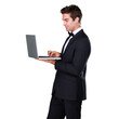 © Arcurs Corp/peopleimages.com - Businessman, typing and standing with laptop for information in png or isolated background for copywriter. Stylish, professional male and looking at display with technology for email or working.