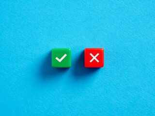 Wall Mural - Right versus wrong. To approve or to reject. Decision making concept. Checkmark and cross symbols on colorful cubes on blue background.