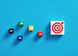 © Cagkan - Competition to achieve business goals. Goal setting, performance and strategy. Colorful cubes with target goal and arrow symbols.