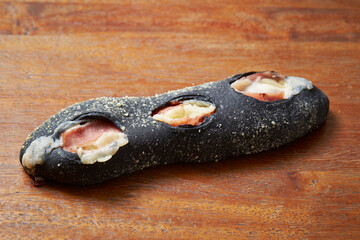 Sticker - Squid ink bread on wooden table