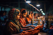 © J S - Asian child labour in fashion textile industry - row of young colorful teenage working girls sewing clothes in a factory with copy space