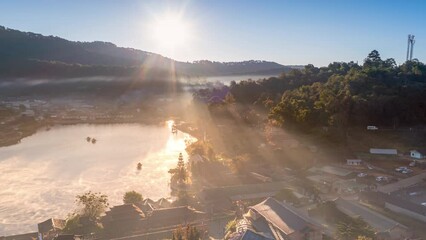 Wall Mural - drone view with fly above lake at baan rak thai village in mae hong son, thailand and go to sunrise 