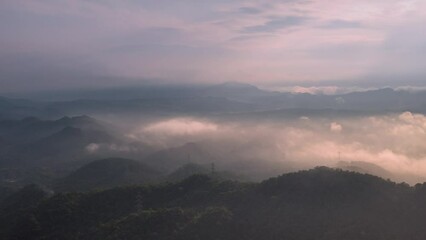 Wall Mural - 4k motion time lapse video aerial view morning scenery mist flowing over the high mountains the move
