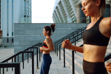 Wall Mural - Two women in sportive clothes have fitness day outdoors together. Sport, Active life, sports training, healthy lifestyle.