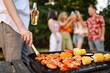 © maxbelchenko - Assorted delicious grilled meat with barbecue grilled vegetables. Сompany of people gathered for barbecue in summer garden. Summer, party, adventure, youth, frienship concept