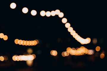 decorative outdoor string lights at night time, defocused background, night city life backdrop, part