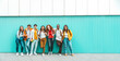 © Davide Angelini - Diverse college students standing together on a blue wall - Photo portrait of multiracial teenagers in front of university building - Life style concept with guys and girls going to highschool
