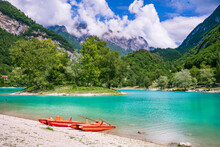 Amazing Beautiful Turquoise Lake Tenno In Trentino Region Of Italy, Surrouded By Alps Mountains.  Panoramic View With Tiny Island And Canoe