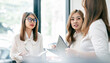 © NAMPIX - Group Of Businesswomen Collaborating In Creative Meeting standing In Modern Office