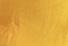 Gold Silk Texture Background. Yellow Shiny Gold Fabric Sheet Surface With Light Reflection, Vibrant Satin Golden Luxury Wallpaper