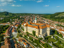Aerial view of restored Baroque Mikulov castle in Southern Bohemia also called Nikolsburg with medieval towers surrounded by communist style houses