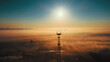 Landscape from drone. Sun on horizon line and fog over industrial industrial zone. Communication tower against sky. Beautiful dawn.