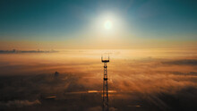 Landscape From Drone. Sun On Horizon Line And Fog Over Industrial Industrial Zone. Communication Tower Against Sky. Beautiful Dawn.