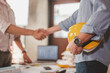 © Garun Studios - blueprint, plan, architect, project, engineer, meeting, brainstorming, teamwork, team, discussion. engineers shake hands for meet up and brainstorm to prepare blueprint architecture project builder.