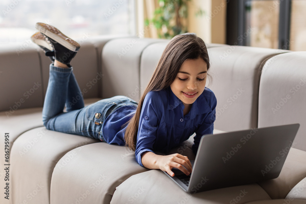 Smiling Girl Using Laptop Computer Relaxing On Couch At Home Stock ...