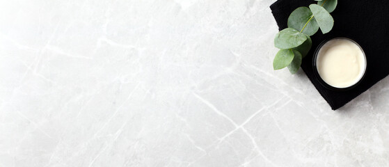 Wall Mural - jar of natural moisturizer cream with eucalyptus leaves on stone background. flat lay, top view, cop