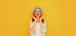 © rohappy - Portrait of happy excited surprised young woman wearing straw hat and sunglasses on yellow background