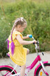 © Evgenia Tiplyashina - Girl to learn to ride a bike.