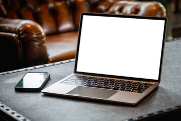 Men using laptop computer displays working at home with a blank white desktop screen monitor and a blank design mockup technology mockup communication marketing and design. 