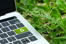 Environmental Technology Concept.green Recycle Button On A Black Keyboard On Green Grass. Recycle Zero Waste Ecology Saving Technology. Circular Technology For Digital And Environmental Sustainability