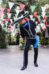 Wall Mural - Latin man wearing as Traditional Mexican mariachi at parade or cultural Festival in Mexico Latin America, hispanic people in independence day or cinco de mayo