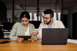 © Drobot Dean - Two indian colleagues using laptop and tablet while working together in office