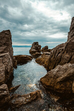 Kvarner Gulf Of Adriatic Sea Rocky Coastline, Large Rocks At Shoreline In Old Town Of Lovran In Croatia