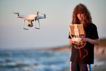 Wall Mural - drone operated by young man flying over an sea