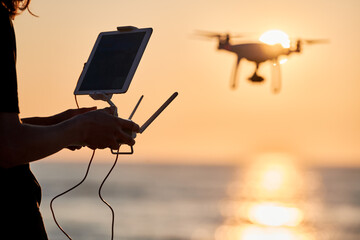 Wall Mural - drone operated by young man flying over an sea
